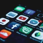 Detailed close-up view of a smartphone screen displaying various popular social media app icons.