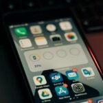 A smartphone with various apps on its screen placed on a keyboard, showing a 31% battery level.